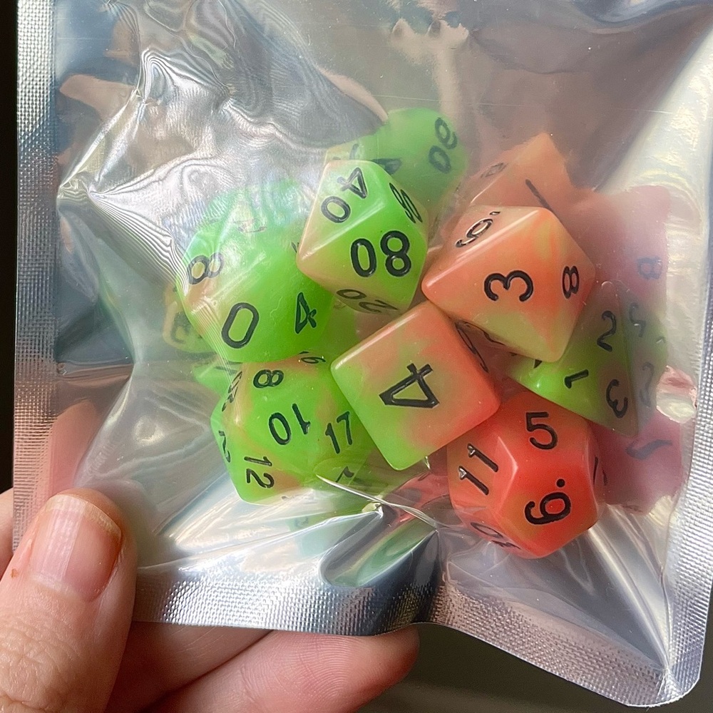 NIB 7-piece glow-in-the-dark green and orange TTRPG dice with black ink